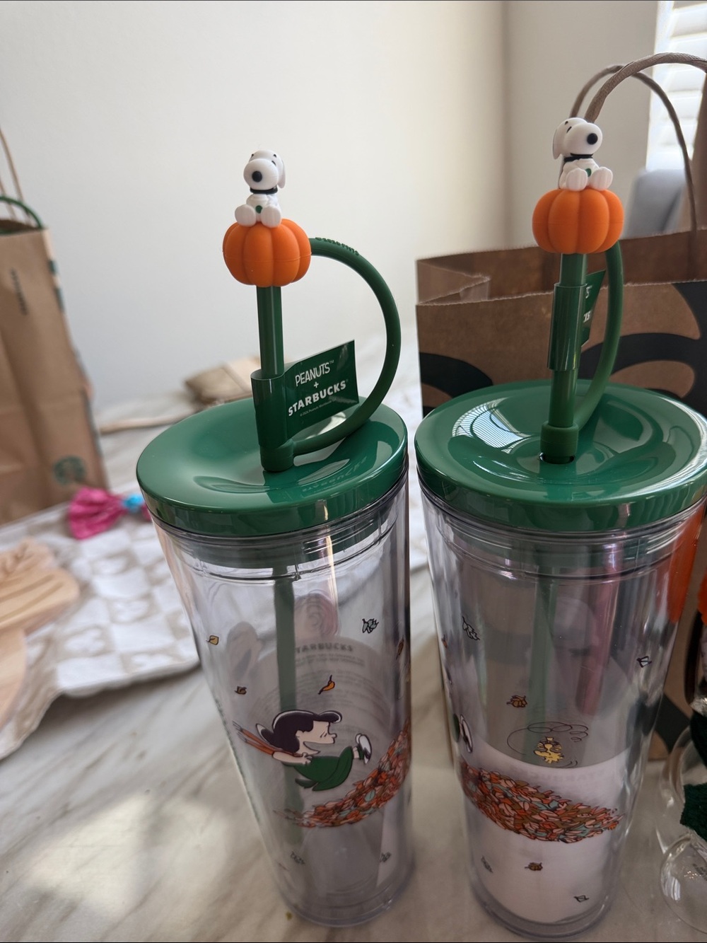 Starbucks Clear Peanuts Tumbler with Green Lid and Orange Pumpkin Topper